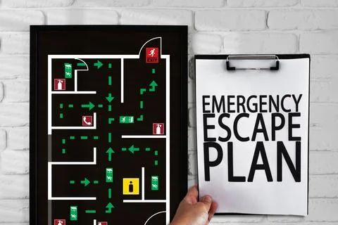 Emergency evacuation plan displayed on wall with detailed escape route in Stock Photos
