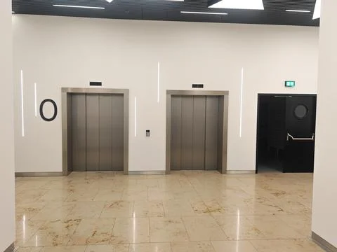 Emergency exit and elevator doors in shopping center of bus station Stock Photos