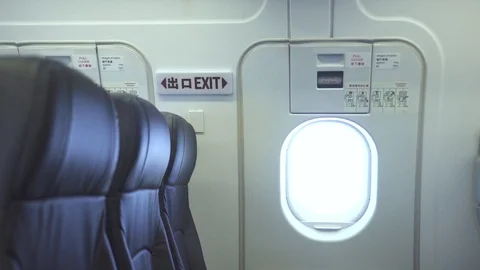 Emergency exit door and empty passenger seats inside commercial airplane 스톡 동영상 105052716