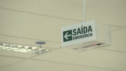 Emergency exit sign nailed to the ceiling of the company Stock Footage 274431278