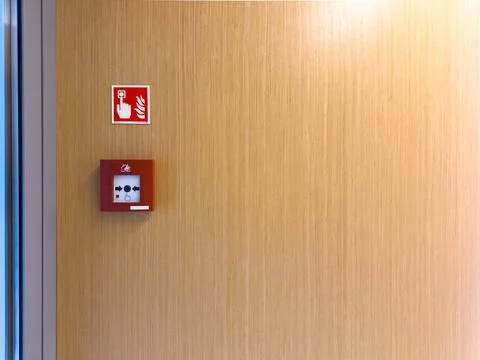 Emergency fire alarm button on wall Stock Photos