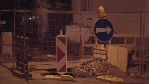 Emergency flashing strobe light on construction with direction sign at night Stock Footage 142074078