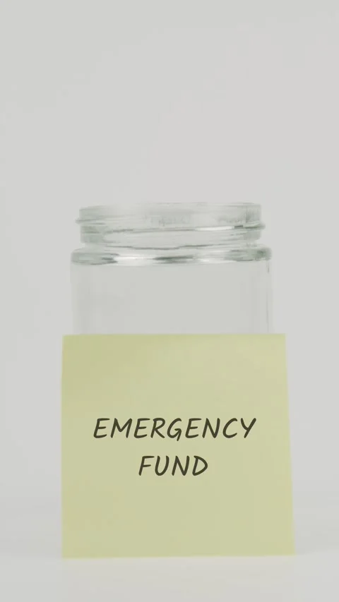 Emergency fund text or word on yellow sticky note attached to glass jar Stock Footage 311725006