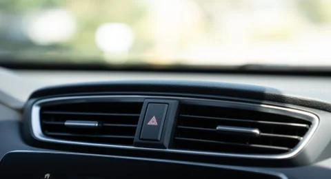 Emergency light button on dashboard of car between air vents Stock Photos