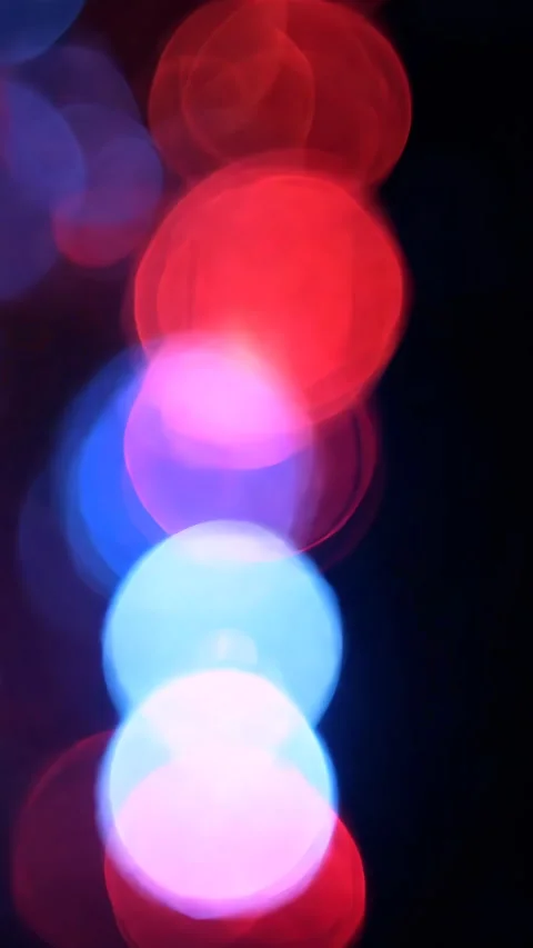 Emergency light reflections blurring into vibrant bokeh pattern. Vertical video. Stock Footage 310776953