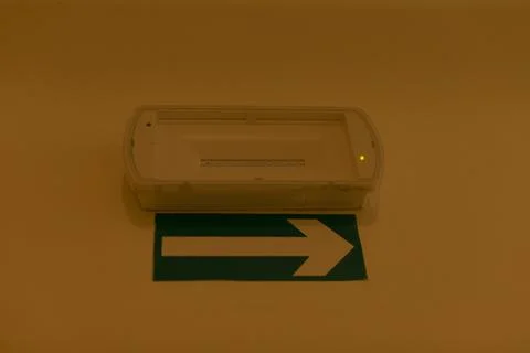 Emergency lighting with precise arrow showing evacuation route clearly Stock Photos