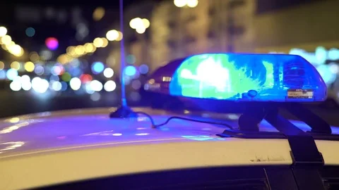 Emergency lights. Blinking police flasher on the roof of the patrol car at night Stock Footage