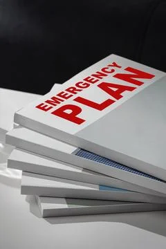 Emergency plan documents stacked on a desk for quick reference in crisis 写真素材