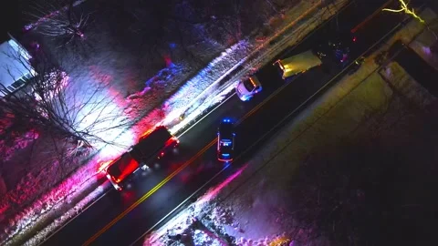 Emergency police fire and utility vehicles responding to auto accident after Stock Footage