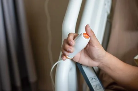 Emergency push button in the hands of patients at the hospital, press to speak Stock Photos