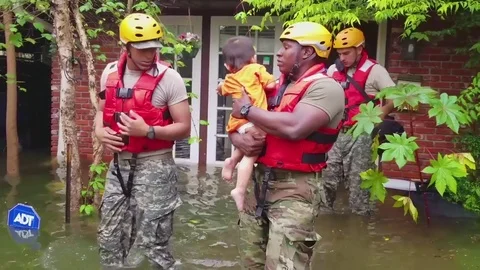 Emergency rescue workers move stranded victims out of harms way during Hurricane Stock Footage