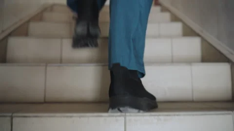 Emergency responder ascends tiled steps quickly. Emergency medical technician Video stock 342337042