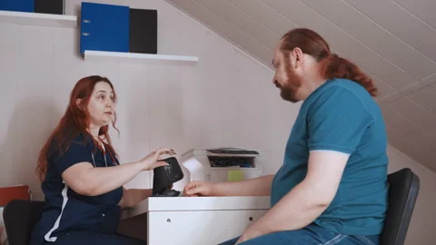 Emergency responder performs swift evaluation at kitchen table. Medical Video stock 342338159