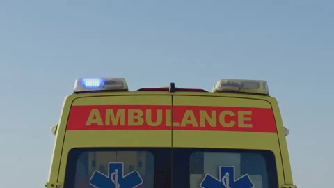 Emergency service vehicle displaying active blue lights in symmetrical Stock Footage 333984168