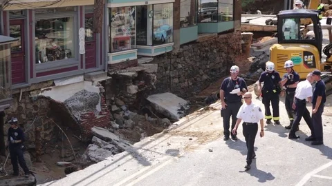 Emergency service workers at flood damaged street after a disaster. Wide. Stock Footage 70538079