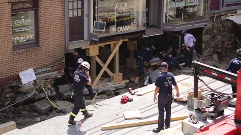 Emergency services at disaster site. Flood damage destroyed building foundation. Stock Footage 70538251