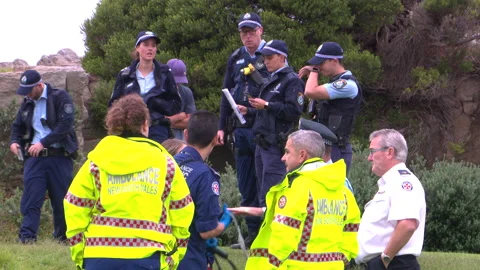 Emergency services undertake cliff rescue with helicopter in Sydney, Australia Stock Footage 132594644