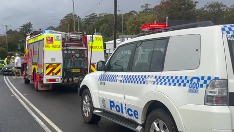 Emergency services work swiftly at the scene of a major two-vehicle Video stock 342578302