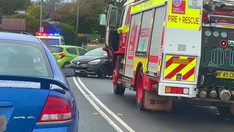Emergency services work swiftly at the scene of a major two-vehicle Stock Footage 342578527