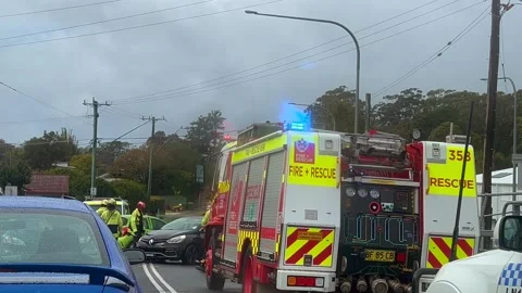 Emergency services work swiftly at the scene of a major two-vehicle Stock Footage 342578532