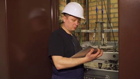 Emergency situation in the building's elevator. Engineer from the technical Stock-Footage 265258293