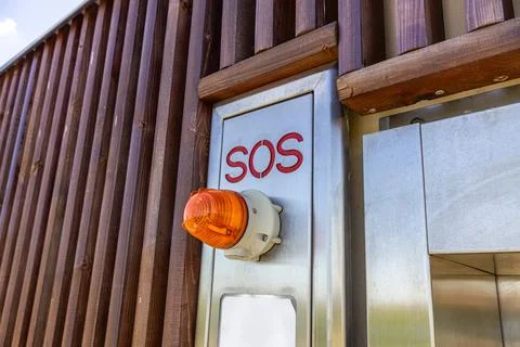 Emergency SOS Button Panel on Modern Public Automated Restroom Stock Photos