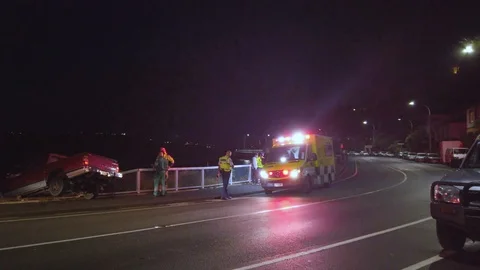 Emergency staff talking to driver to ensure he is uninjured after traffic Stock Footage 104671349