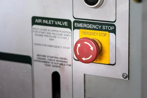 An emergency stop (ESD) button on the engine control panel. Stock Photos
