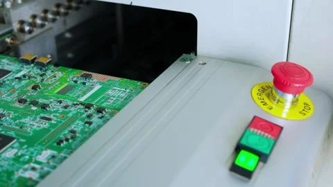 Emergency stop procedure on PCB assembly machine in electronics factory Stock Footage 325445282