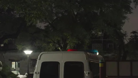 Emergency team arrives amid dramatic urban nighttime atmosphere. Red and blue Video stock 335070097