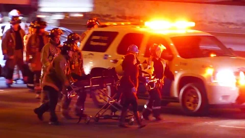Emergency team carrying stretcher while doing CPR on car crash victim Stock Footage 77892684