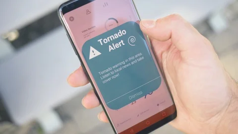 Emergency Tornado Alert Notification on a Smartphone Screen Stock Footage 110802512