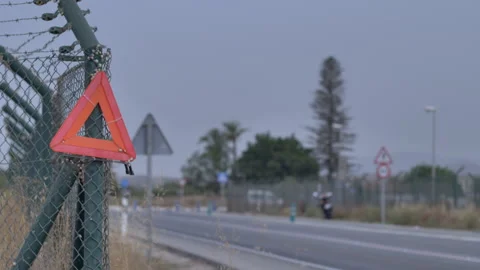 Emergency Triangle Tied to Barbed Wire Fence with Van Stock Footage 346008846
