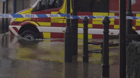 Emergency vehicles driving through flood water, Bradford on Avon, UK Stock Footage 33748474