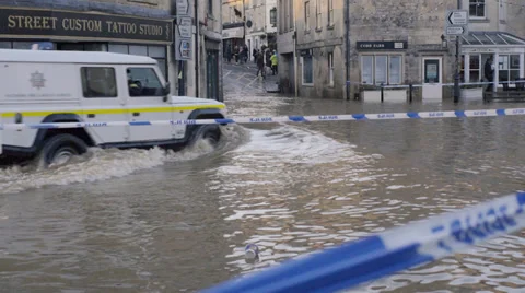 Emergency vehicles driving through flood water, Bradford on Avon, UK Stock Footage