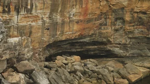 Emergency worker climbing down The Gap cliff top to retrieve a body Stock Footage 264989045