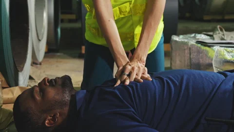 Emergency on worker in factory, First aid emergency CPR on heart attack Man.. Stock Footage 242714595
