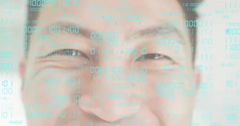 Emerging binary code overlay shifting across man's face, illustrating digital Video stock 318738663