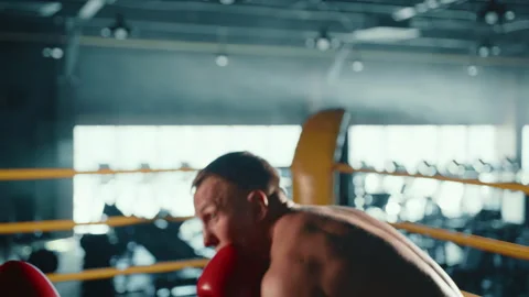 Emerging Boxer Engages in Intensive Training with Personal Coach in Gym Stock Footage 273746770