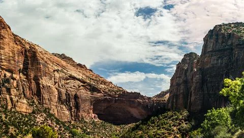 Emerging sandstone arch between high rock in american nature in Zion national 스톡 사진