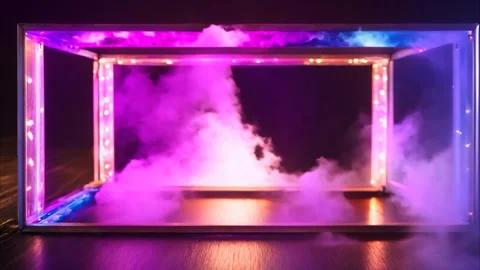 Emerging smoke inside a cube forming a frame with glowing neon lights on a .. Vídeos de archivo 273954653