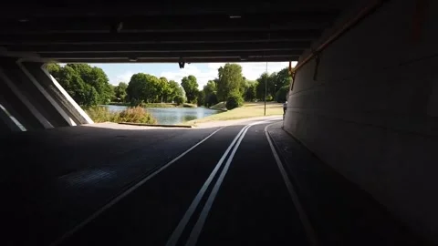 Emerging from tunnel to scenic river path Stock Footage 330138589