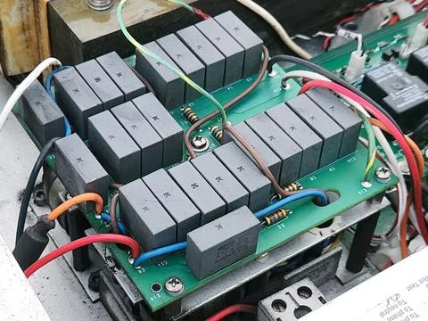 EMI Filter Board with Rows of Gray Capacitors. Stock Photos