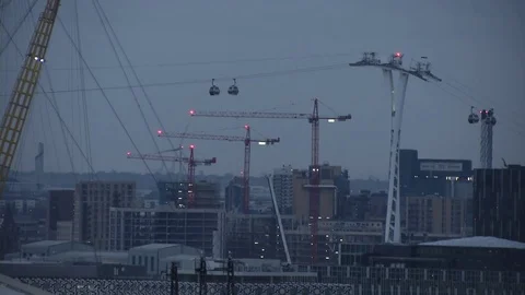Emirates air line cable car at night long shot building sites in background Stock Footage 74230041