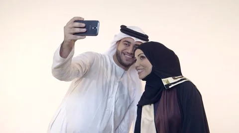 Emirati couple taking selfie using mobile camera. Stock Footage 54487770