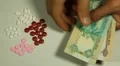 Emirati Dirham AED, Counting Drugs and Money, Health Care, Colorful Pills HD Footage
