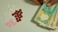 Emirati Dirham AED, Counting Drugs and Money, Health Care, Colorful Pills HD Footage