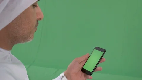 Emirati man using a smartphone Stock Footage 94481539