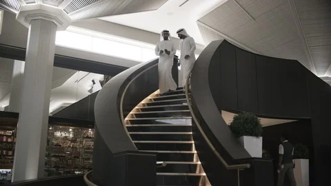 Emirati men walking down the staircase Stock Footage 108493208