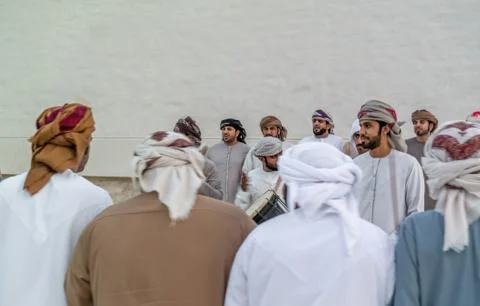 Emirati Middle Eastern Men performing the Yowla, a traditional dance Stock Photos